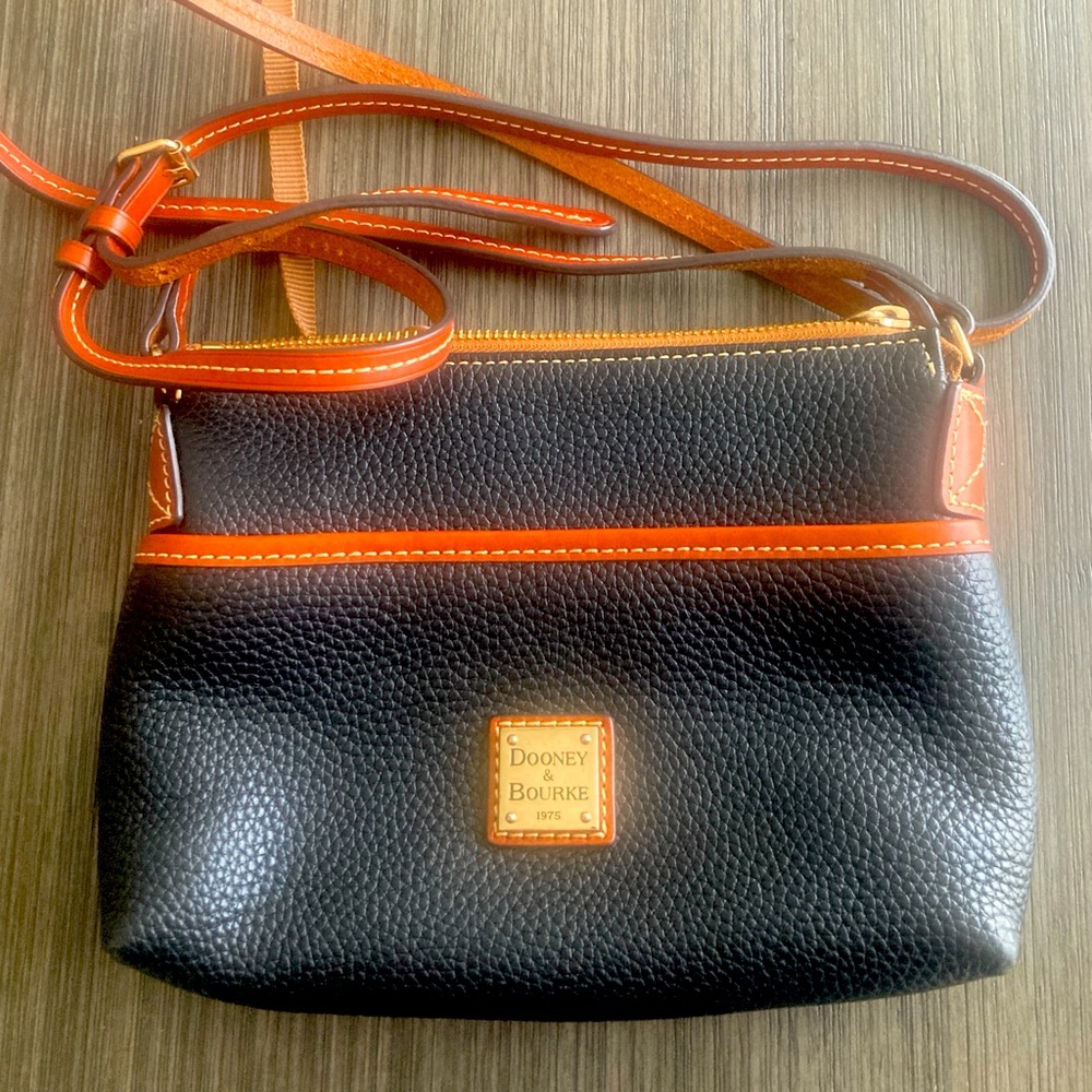 Dooney & Bourke Black and Brown Crossbody Bag. Small nick on back